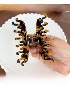 Close-up of tortoise shell pattern hair claw with a durable golden metal spring
