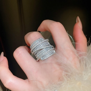 Close-up of a silver multi-layer interlocking ring with sparkling zircon stones