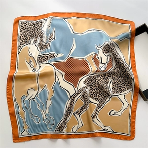 Detailed pattern of leopard print and horse motif on a silky square neck scarf