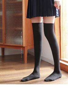 Detail of black over-the-knee socks with compression effect in a preppy JK style look