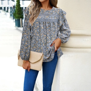 Floral print long sleeve blouse with lace trim and ruffled details on blue fabric