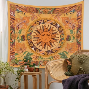 Cozy room interior featuring a bohemian sun and zodiac tapestry on a white wall