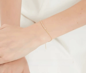 Detailed view of S925 silver bracelet with sparkling zircon square on a model's wrist