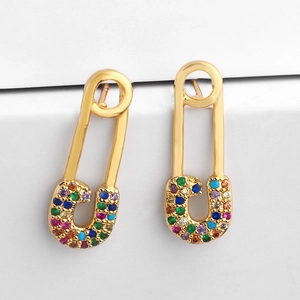 Golden safety pin earrings featuring colorful zircon stones in a modern fashion style