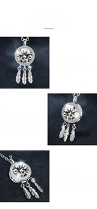 Detail view of moissanite dreamcatcher pendant with feather charms and polished silver finish
