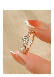 Macro shot of a rose gold ring featuring a large main stone and accent side diamonds
