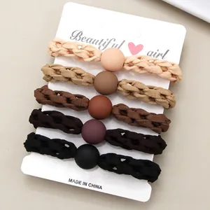 Five-piece set of woven hair ties in neutral earth tones with matte round bead accents