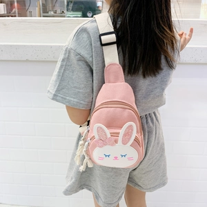Child wearing a pink canvas rabbit chest bag with glitter ears and adjustable strap