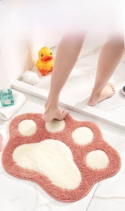 Detail of pink cat paw bath mat featuring thick absorbent flocking and non-slip bottom texture