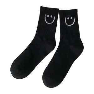 High-quality black mid-calf cotton socks featuring white embroidered smiley face patterns