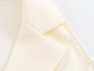 Close-up detail of beige woven blazer neckline with high-quality stitching and texture