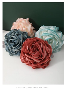 Close-up of rose-shaped bath sponge set with textured PE mesh in four vibrant colors