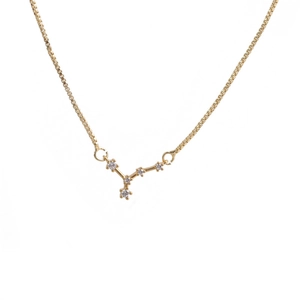 Macro shot of gold box chain and geometric constellation pendant with sparkling zircon