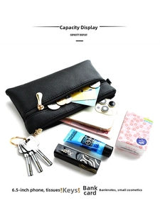 Internal capacity display of a black lychee leather crossbody bag with items inside