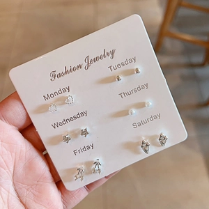 Detail of 6-pair silver stud earring set with heart, star, and pearl designs on card