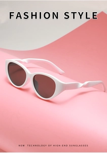 Nahaufnahme der Cat-Eye-Sonnenbrille mit gedrehtem Bügeldesign und weißem Rahmen