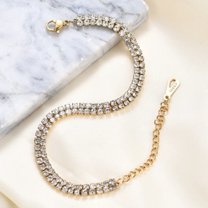 Macro detail of 6mm double row crystal tennis bracelet in 14K gold plated stainless steel