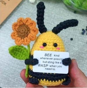 Handmade crochet honey bee plush toy holding a sunflower and inspirational card
