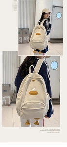 Detail view of beige corduroy backpack with cute 3D duck and adjustable straps