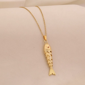 Close-up of golden fish pendant with colorful enamel scales and intricate metal textures