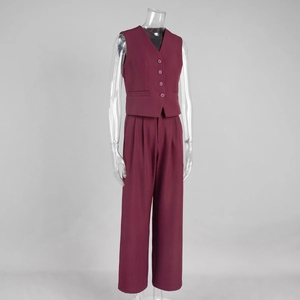 Detail of burgundy business vest and wide-leg trousers set with buttons and pockets