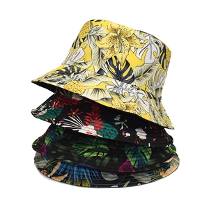 Double-sided reversible bucket hats with tropical leaf and floral prints for sun protection