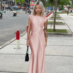 Detail of pink sleeveless satin dress with asymmetric neckline and waist pleat texture