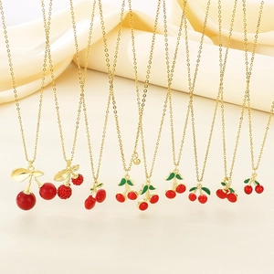 Gold stainless steel necklace collection with red cherry pendants and green leaf charms