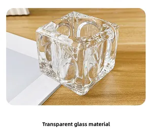 Close-up of thick transparent square glass candle holder with high clarity on wood surface