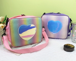 Detail of glitter rainbow lunch bag with holographic heart patch and side mesh pocket