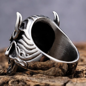 Macro shot of vintage gothic Hannya mask ring in stainless steel with aged silver finish