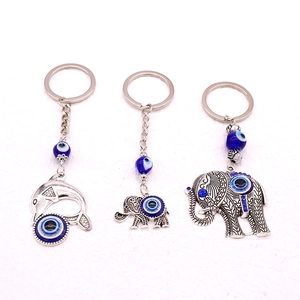 Ethnic silver evil eye keychains featuring dolphin and elephant animal pendant designs