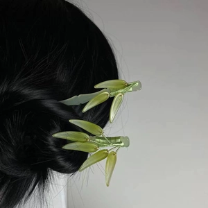 Pair of minimalist green leaf hair sticks made of resin for modern oriental style hair updo