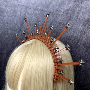 Detail of halo crown headband featuring brown spikes and silver metal star rivets