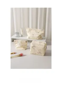 Three-piece beige canvas makeup bag set with black polka dots and elegant ribbon bows