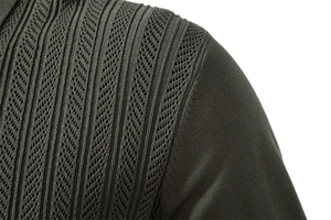 Close-up of olive green knit sweater showing shoulder texture and precision stitching
