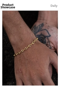 Detail view of a men's 18K gold plated stainless steel chunky chain link bracelet on wrist