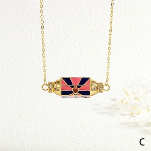 Close-up of hexagonal enamel eye pendant with sparkling zircons and a small red heart stone