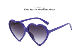 Detail of heart-shaped sunglasses featuring a purple frame and gradient gray lenses