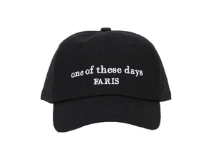 Detailed white embroidery of 'one of these days FARIS' text on a black cotton baseball cap