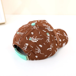 Brown kids dinosaur skeleton baseball cap with mint green accents and adjustable strap