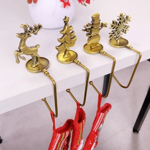 Set of 4 bronze metal Christmas stocking hooks with reindeer, tree, and snowman icons