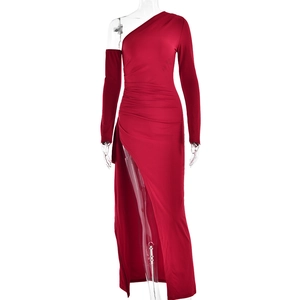 Detail of red one-shoulder long sleeve dress with high slit and elastic glossy fabric