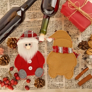 Christmas Santa and reindeer felt cutlery holders on festive table with pine cones
