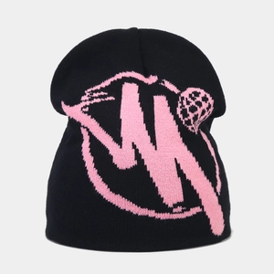Close-up of black knit beanie featuring bold pink graphic logo with fine ribbed texture