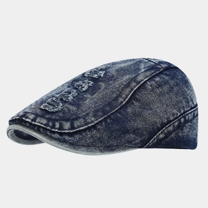 Detailed view of DEANS embroidery and distressed denim edges on the navy blue ivy cap