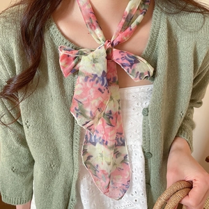 Close-up of elegant floral print mesh scarf necklace with pastoral bow tie design