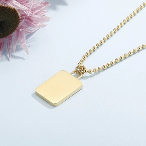 Detail of 18K gold plated bead chain with a minimalist polished rectangular pendant
