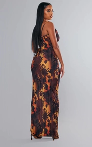 Detail of slim fit pleated maxi dress featuring orange floral print and spaghetti straps