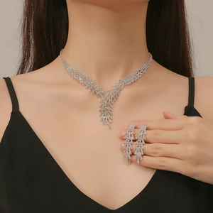 Silver fringe necklace and earring set with shimmering stones worn by a model